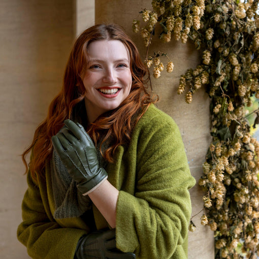 Woman wearing heritage touchscreen wool-lined leather gloves in sage/beige