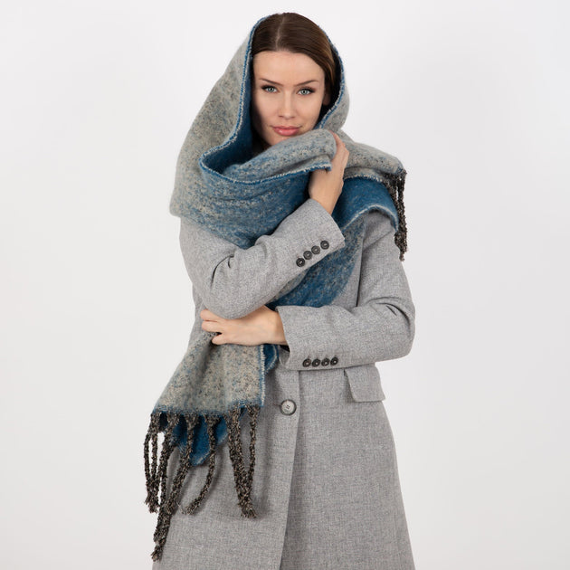 Woman wearing Kingfisher Reversible Ombre Blanket Scarf with a grey coat